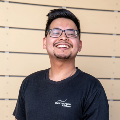 Tom Siri smiling with glasses on.