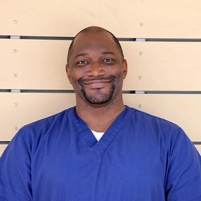 Maasge Therapist Marcus Oliver In Front Of Wooden Wall
